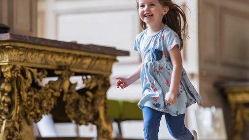 Young girl running in the Long Gallery at The Children's County House, Sudbury, Derbyshire
